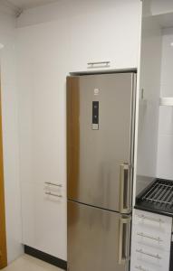 a stainless steel refrigerator in a kitchen at Apartamentos Gallaecia in Val do Dubra