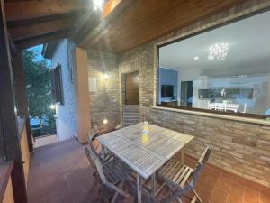 a wooden table and chairs on a patio at Casa Drema - Villa al mare con terrazza in Pescara