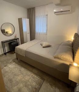 a bedroom with a large bed and a mirror at Villa Scandinavia in Mostar