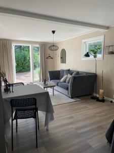 a living room with a couch and a table at Hallonet in Alingsås