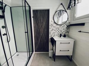 a bathroom with a shower and a sink and a mirror at Domek Letniskowy Dario in Ińsko +28 photos