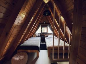 a small room with two beds in a attic at Domek Letniskowy Dario in Ińsko
