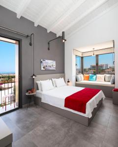 a bedroom with a large white bed and windows at Yerli Alaçatı in Alaçatı