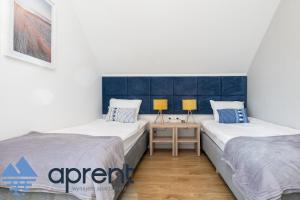 Ένα ή περισσότερα κρεβάτια σε δωμάτιο στο Dom Sosnowe Zacisze Horizon Park - Aprent
