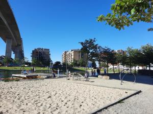 a park with a bridge and people on a beach at Gabriel's Home in Stavanger