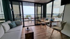 a living room with a couch and a table at Hausboot Aava in Schleswig