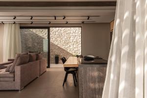 a living room with a couch and a table at Limnionas Serenity Cave Villa in Kampion