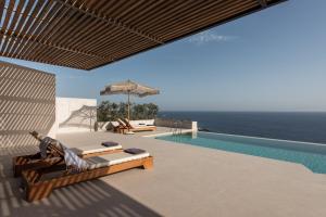 a villa with a swimming pool and a patio at Limnionas Serenity Cave Villa in Kampion