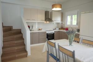 a kitchen with a table with a vase on it at Single House by the Sea in Kato Alepochori