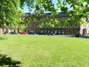 
a large building with a large lawn in front of it at 18 The Circus Apartment in Bath
