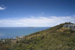 a view of the ocean from a hill with condos at Happy Days Villa B in Fajardo