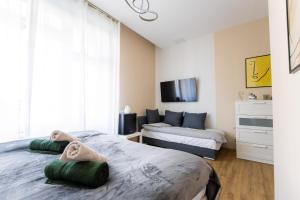 a bedroom with two beds with towels on them at Beautiful View Duna Apartment in Budapest