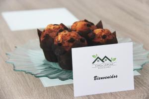 a plate of chocolate muffins on a table with a sign at Bungalows en La Oliva Vejer in El Soto