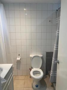 a small bathroom with a toilet and a sink at Petals Lovely Beach Villa in Saint Johnʼs