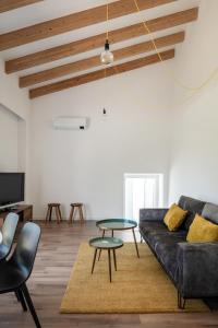 een woonkamer met een bank en een tafel bij Casa Monte dos Entrudos in Almancil