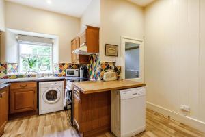 a kitchen with a washing machine and a washer and dryer at Reiver's Rest in Bellingham
