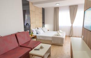 a hotel room with a bed and a couch at RIBAR APARTMENTS in Ohrid
