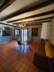 a living room with a couch and chairs and a table at Casa do Cruzeiro in Aguiar da Beira