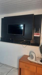 a flat screen tv hanging on a wall at ACONCHEGO DE CANELA/RS in Canela