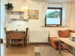 a living room with a table and a desk at Pretty apartment in Mittersill with a view in Mittersill