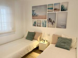 Posteľ alebo postele v izbe v ubytovaní Tarifa Cozy House - Central - Parking - Wifi