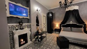 a bedroom with a fireplace and a bed and a tv at Anzio d'aMare in Anzio