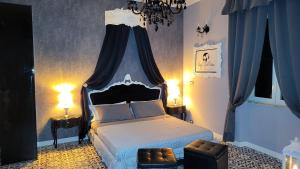 a bedroom with a bed with a blue canopy at Anzio d'aMare in Anzio +33 photos