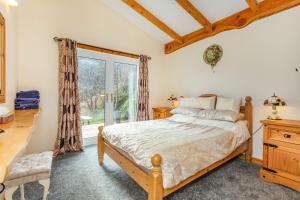 a bedroom with a bed and a window at Druidaig Cottage in Letterfearn