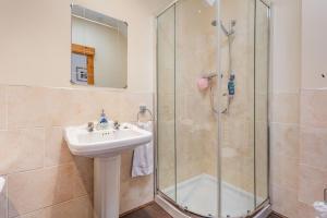 a bathroom with a sink and a shower at Druidaig Cottage in Letterfearn +25 photos