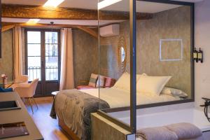 a bedroom with a bed with a glass wall at Ferrari Suites in Valladolid