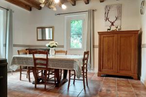 Un comedor con mesa y sillas en Le Seigneur des Bois, en Bussière-Galant