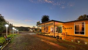 a building with a bench next to a street at Bushmans Motor Inn in Gundagai