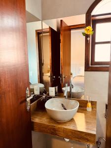 a bathroom with a large bowl sink and a mirror at Hotel do Parque - Cunha in Cunha +49 photos