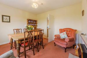 a dining room with a table and chairs at Meadow Lea in Leominster