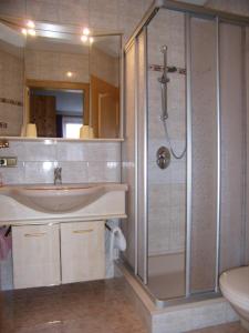a bathroom with a shower and a sink at Appartementhaus Egger in Kaprun