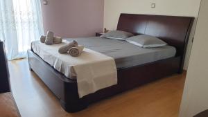 a bedroom with a large bed with towels on it at Wonderful Spot to Recharge in Kalamata
