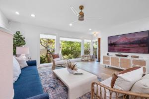 a living room with a blue couch and a tv at Hideaway Zen in San Diego