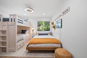a bedroom with two beds and a bunk bed at Hideaway Zen in San Diego