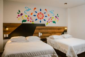 Postel nebo postele na pokoji v ubytování Platero Hotel