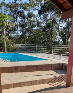 a swimming pool with a fence around it at Casa em São Roque Com belissima vista. in São Roque