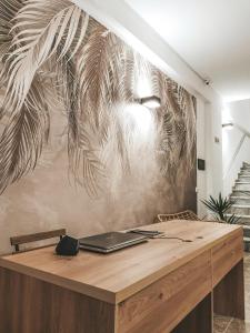 a wooden desk with a laptop on top of it at Arda Beachside Living in Durrës