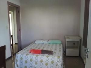a bedroom with a bed with a polka dot blanket on it at Hostel e Pousada do Bosque in Rio Branco