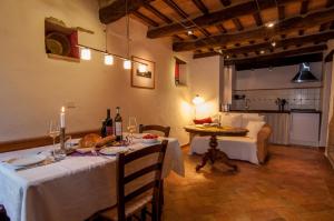 a dining room with a table and a living room at Case Leonori in Treia