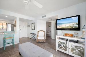 a living room with a flat screen tv on a wall at Ocean Village Club D23 in Saint Augustine