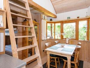 a kitchen and dining room with a ladder and a table at Holiday home Hovborg V in Hovborg