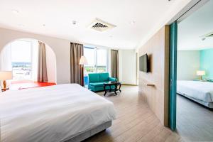 Voodi või voodid majutusasutuse Kenting Long Beach Hotel toas
