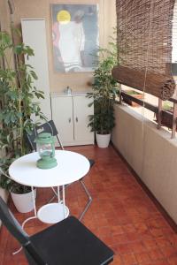 a table and chairs in a room with plants at Apartment "da Max" in Palermo