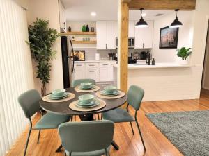 a dining room with a table and chairs and a kitchen at Modern Home in Central San Antonio! in San Antonio