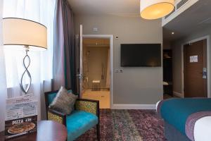 ein Hotelzimmer mit einem Bett und einem TV in der Unterkunft Admiral of the Humber Wetherspoon in Hull