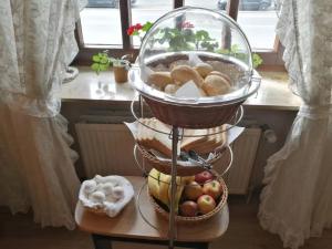 a basket of bread and vegetables on a stand at Hotel Hanseatic-garni in Wuppertal
